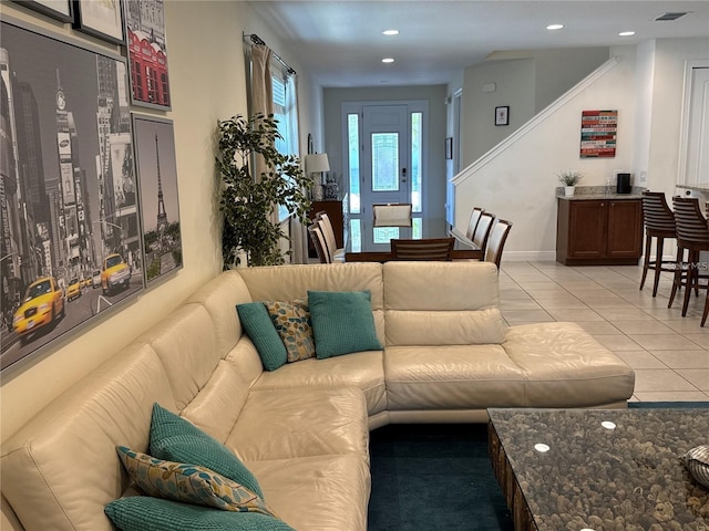 living room with light tile patterned floors, baseboards, and recessed lighting