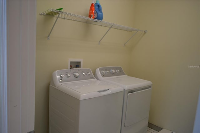 clothes washing area featuring laundry area and washing machine and clothes dryer