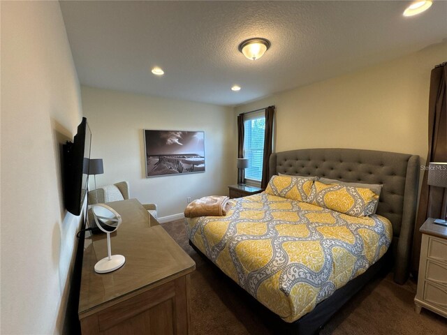 bedroom featuring recessed lighting, dark carpet, a textured ceiling, and baseboards
