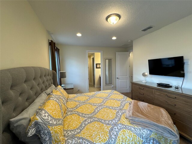 bedroom with recessed lighting, visible vents, and a textured ceiling