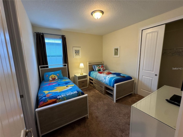 bedroom with carpet floors and a textured ceiling