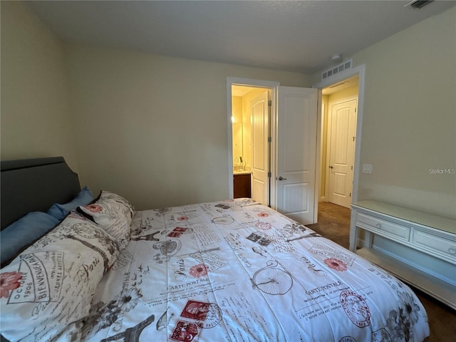 bedroom with visible vents and dark carpet