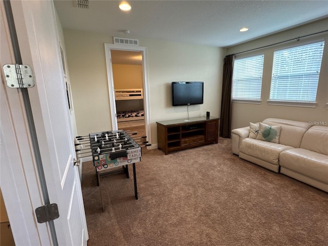 living area with carpet, visible vents, and recessed lighting