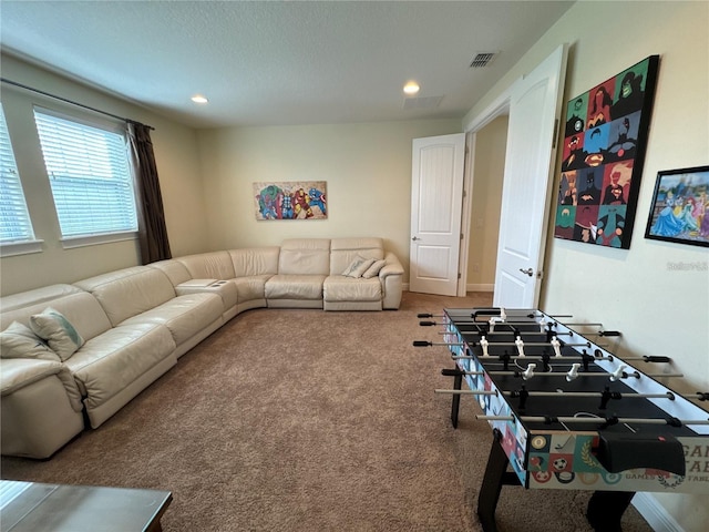 living room with carpet flooring, visible vents, and recessed lighting