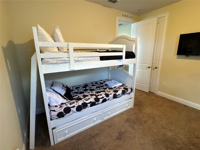 carpeted bedroom with baseboards and visible vents