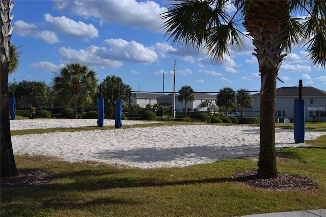 surrounding community featuring a yard and volleyball court