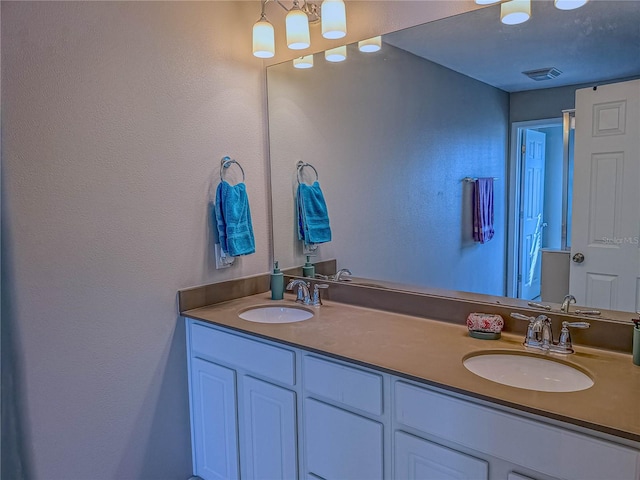 3593 Brighton Park Cir, Belle Isle, FL 32812 - bathroom featuring double vanity, a sink, and visible vents