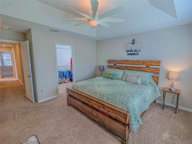 3593 Brighton Park Cir, Belle Isle, FL 32812 - carpeted bedroom featuring a textured ceiling, a walk in closet, visible vents, and baseboards