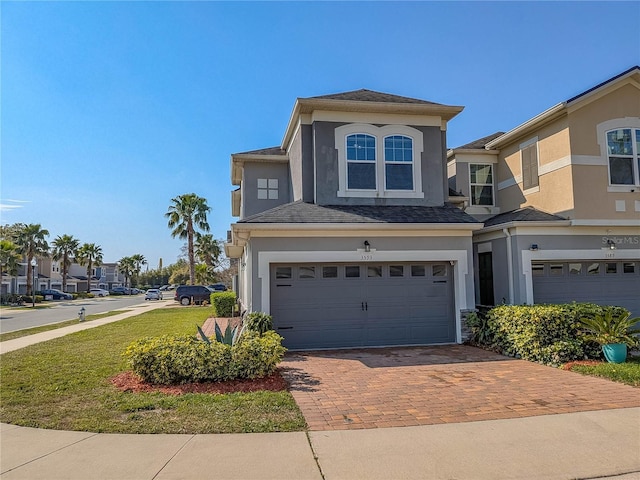 3593 Brighton Park Cir, Belle Isle, FL 32812 - view of front of property featuring an attached garage, a residential view, decorative driveway, and stucco siding