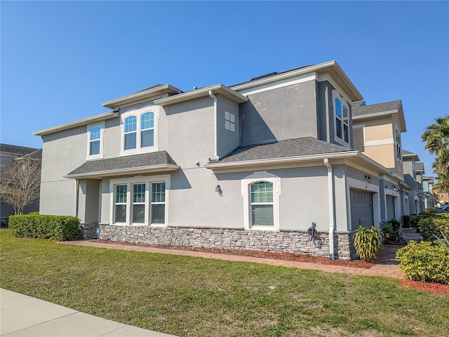 3593 Brighton Park Cir, Belle Isle, FL 32812 - view of home's exterior with stone siding, a yard, an attached garage, and stucco siding