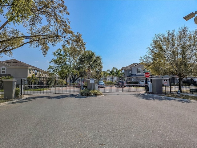 3593 Brighton Park Cir, Belle Isle, FL 32812 - view of road featuring traffic signs, a gate, a residential view, and a gated entry