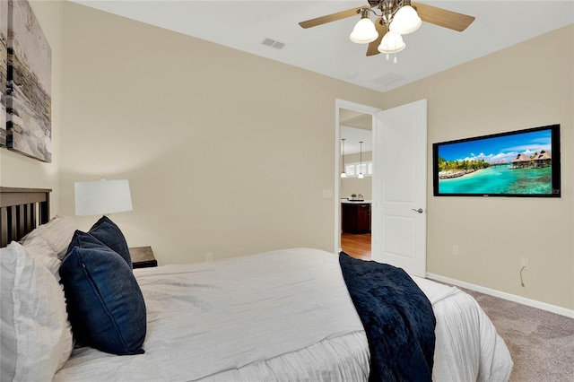 carpeted bedroom featuring baseboards, visible vents, and ceiling fan