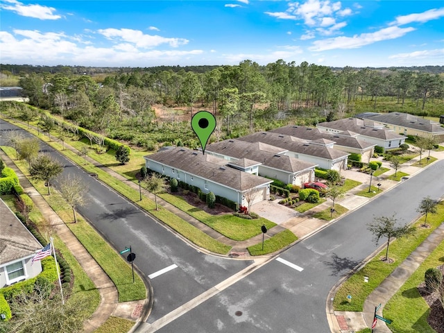 drone / aerial view featuring a wooded view