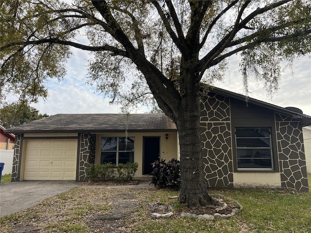 view of front of house with aphalt driveway and an attached garage