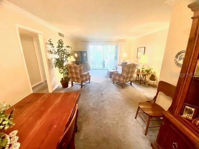 living area featuring carpet floors, visible vents, and ornamental molding