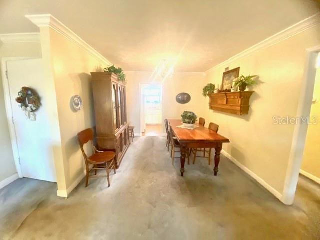 interior space featuring crown molding and baseboards