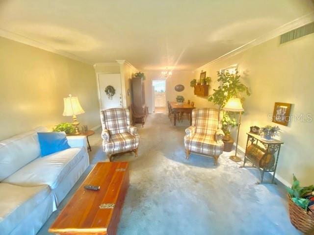 living area featuring visible vents, baseboards, a chandelier, and crown molding