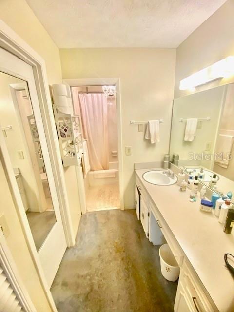 full bath with concrete floors, shower / bath combo, and vanity