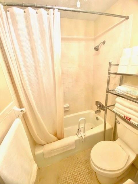 full bathroom featuring toilet, shower / tub combo, and tile patterned flooring