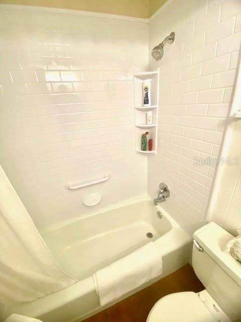 full bathroom with toilet and shower / tub combo with curtain