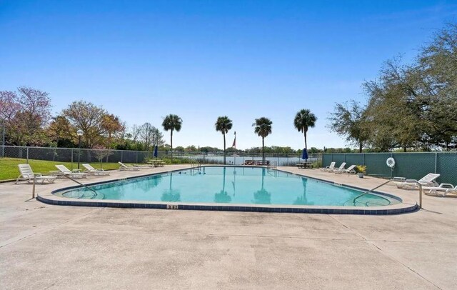 community pool featuring a patio and fence