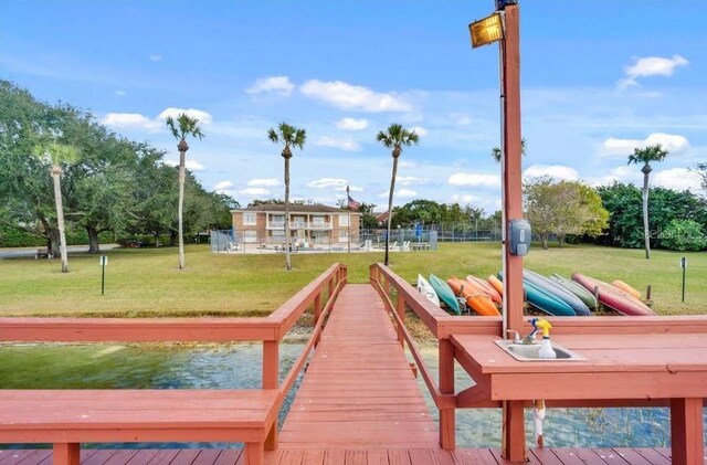 view of dock featuring a lawn