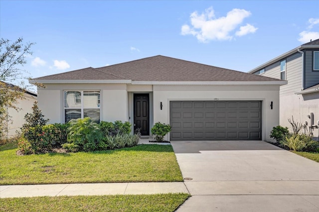 ranch-style house featuring an attached garage, driveway, roof with shingles, stucco siding, and a front yard