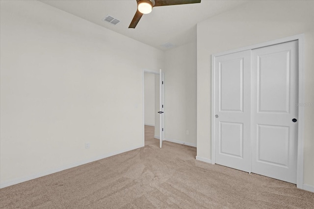 unfurnished bedroom featuring baseboards, visible vents, a ceiling fan, carpet flooring, and a closet