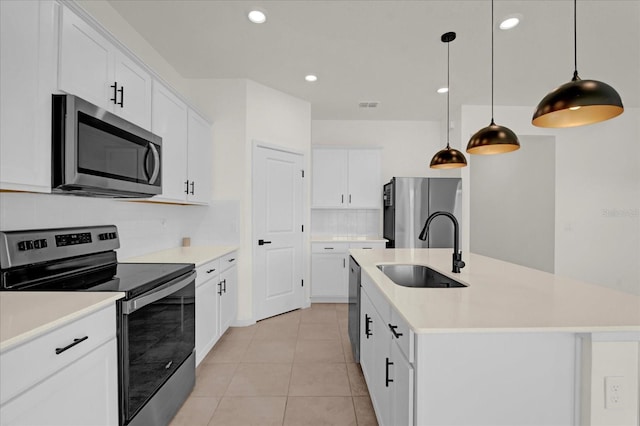 kitchen featuring appliances with stainless steel finishes, light countertops, a sink, and light tile patterned flooring