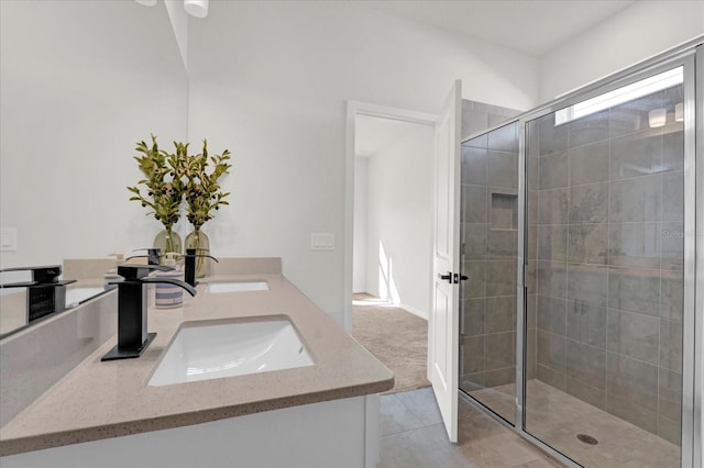 full bath with a stall shower, tile patterned flooring, a sink, and double vanity