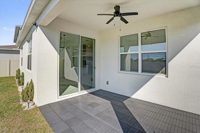 view of patio featuring ceiling fan and fence