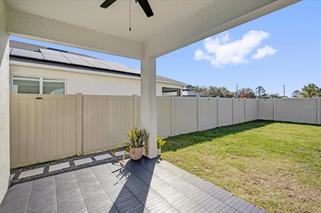 view of yard with a patio, a fenced backyard, and a ceiling fan