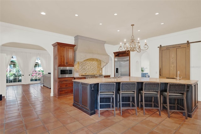 kitchen featuring arched walkways, crown molding, decorative backsplash, built in appliances, and custom exhaust hood