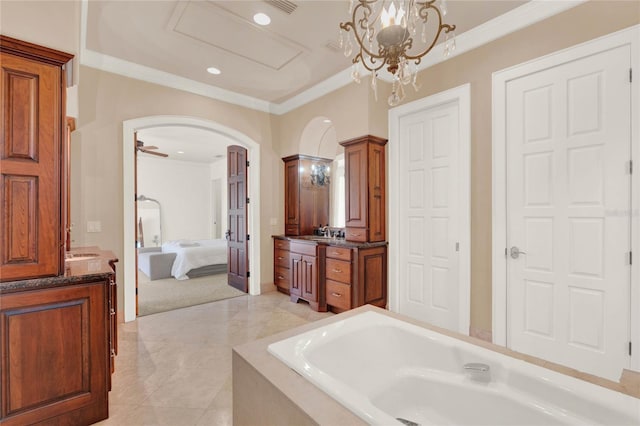 ensuite bathroom with connected bathroom, a bathing tub, vanity, and crown molding