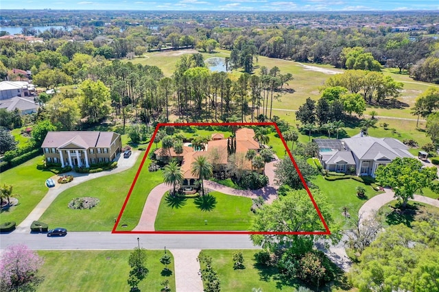 birds eye view of property with a view of trees