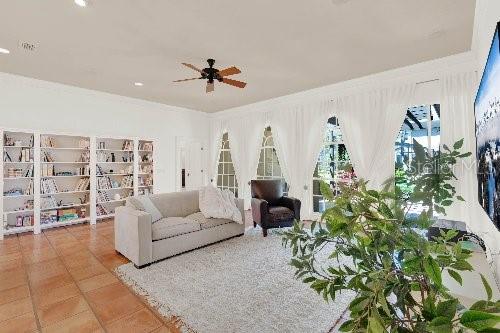 tiled living room featuring a ceiling fan