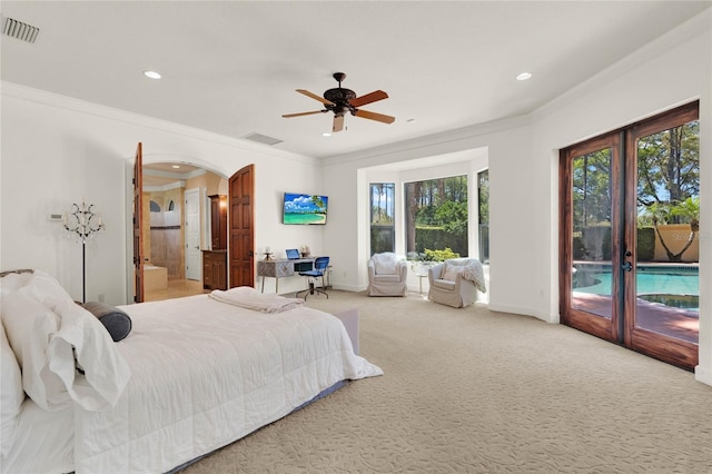 bedroom featuring visible vents, arched walkways, crown molding, access to outside, and carpet flooring