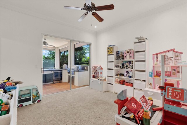 playroom featuring ceiling fan, carpet, wine cooler, ornamental molding, and recessed lighting