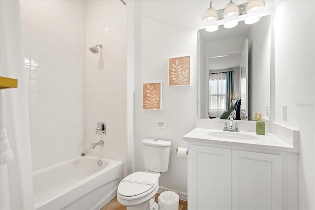 full bathroom with baseboards, toilet,  shower combination, and vanity