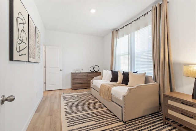 interior space with baseboards and light wood finished floors