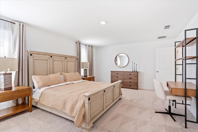 bedroom with visible vents, light carpet, and baseboards