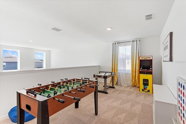 game room with visible vents, a healthy amount of sunlight, and carpet