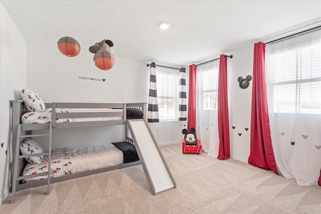 carpeted bedroom featuring baseboards