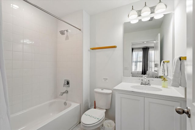 bathroom featuring vanity, toilet, and shower / washtub combination