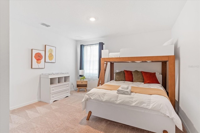 carpeted bedroom featuring visible vents and baseboards