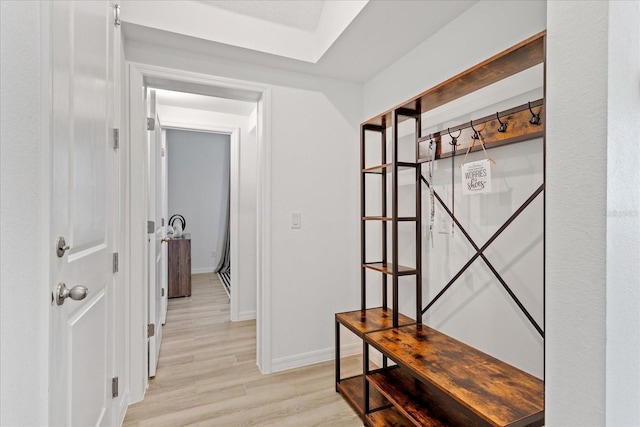 hallway with light wood-style flooring and baseboards