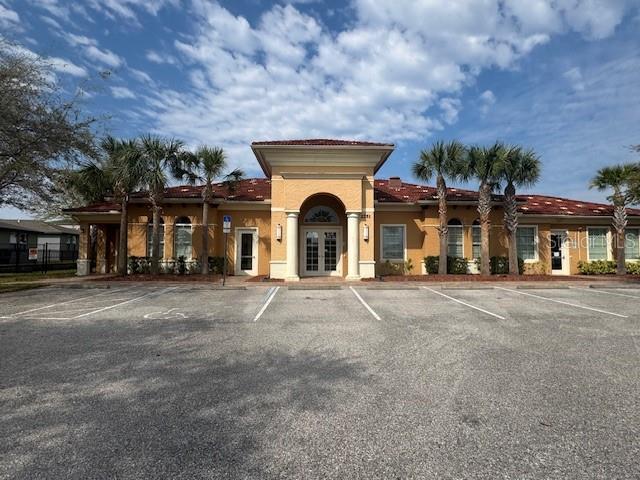 view of building exterior featuring uncovered parking