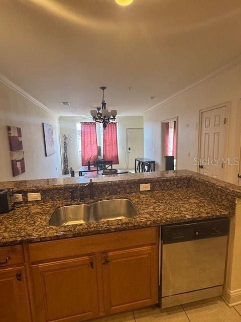 kitchen featuring a sink, dark stone countertops, brown cabinets, and dishwasher