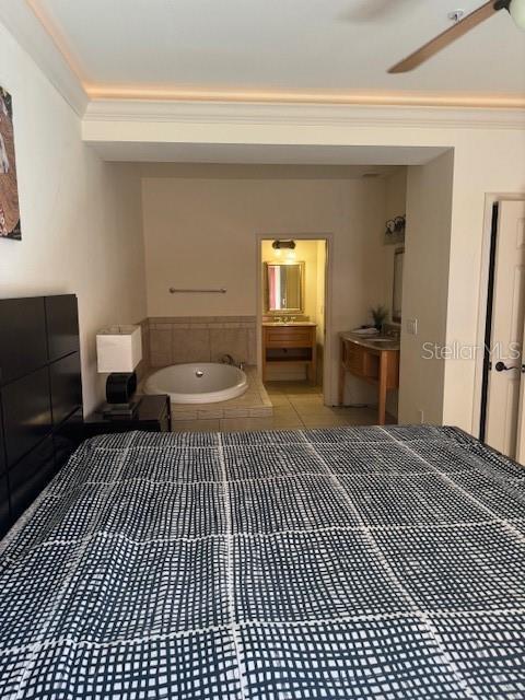 full bath featuring ornamental molding, a garden tub, and tile patterned floors