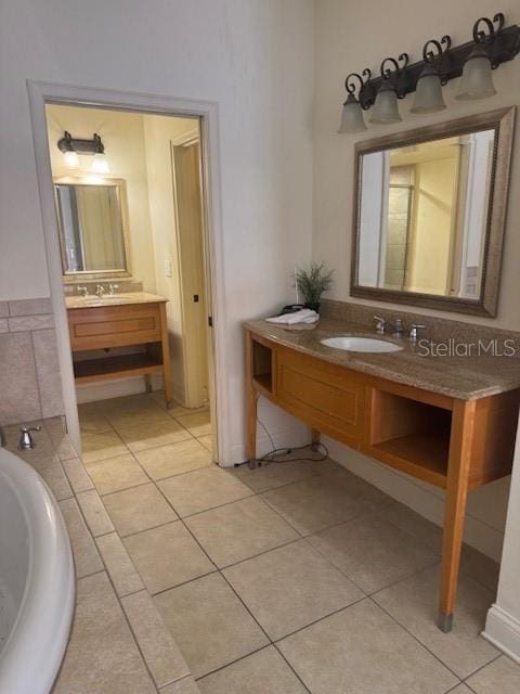 bathroom with two vanities, a sink, and tile patterned floors